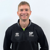 Headshot of Iain smiling at camera