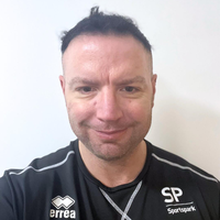 Headshot of Aaron smiling at camera.