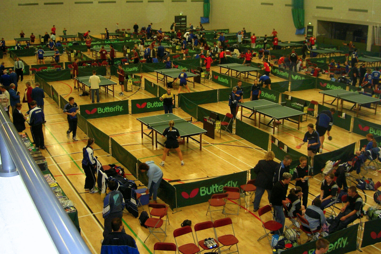 Sports hall full of table tennis courts.