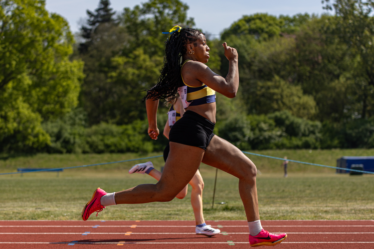 girl sprinting on athletics track in race