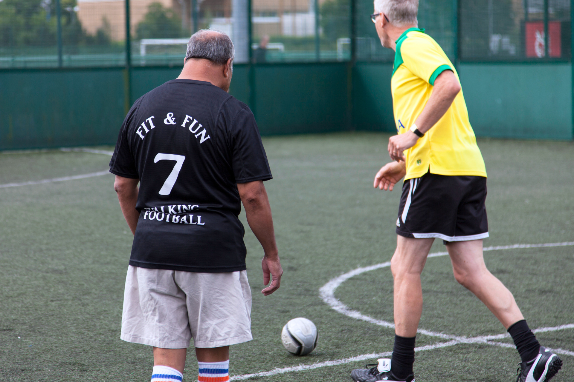 Two men playing walking football.