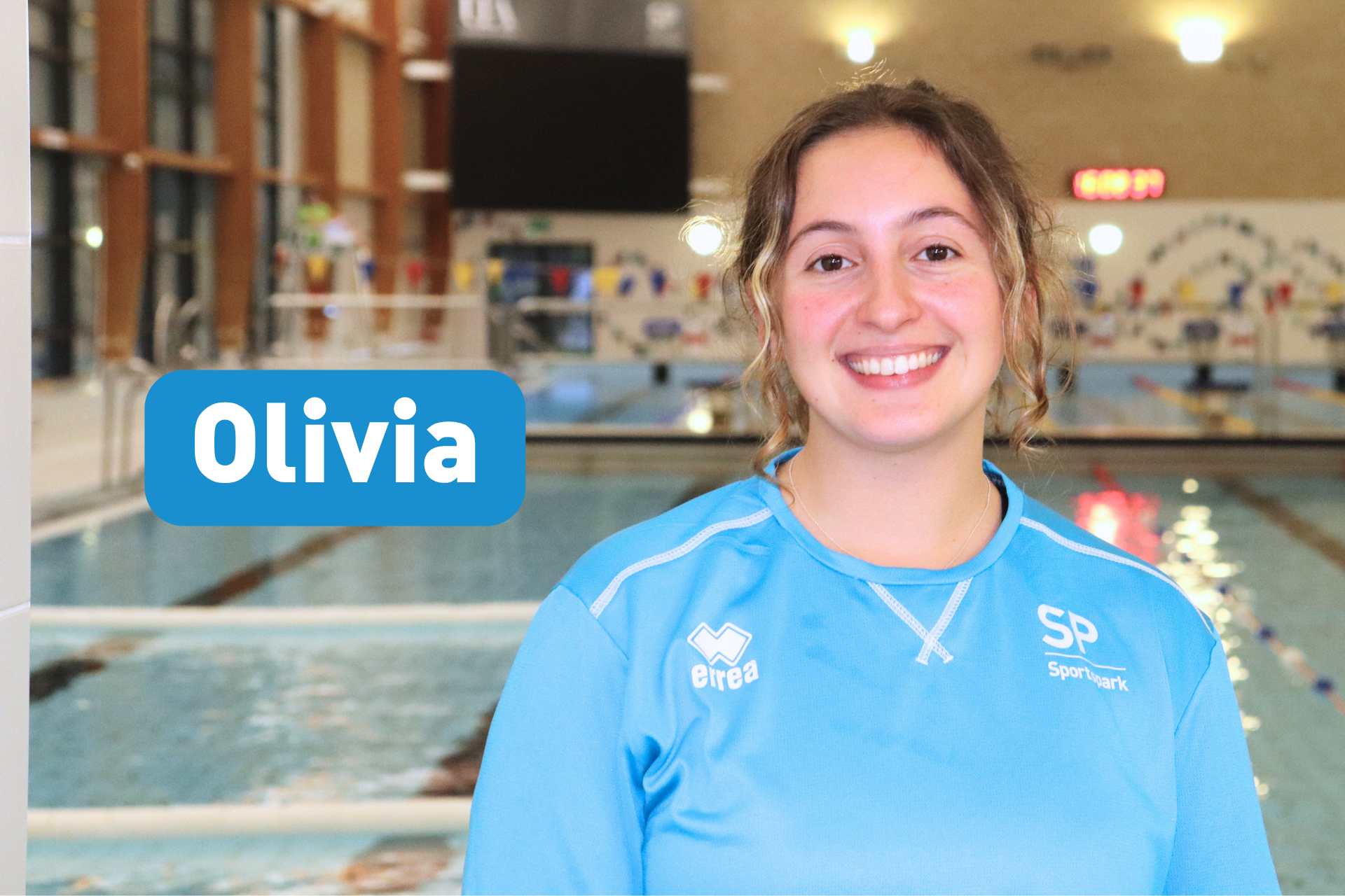 Headshot of Olivia smiling at camera standing in front of pool