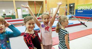 four girls at birthday party in gymnastics centre