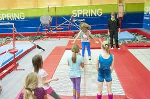 young girl jumping on trampoline in gymnastics centre