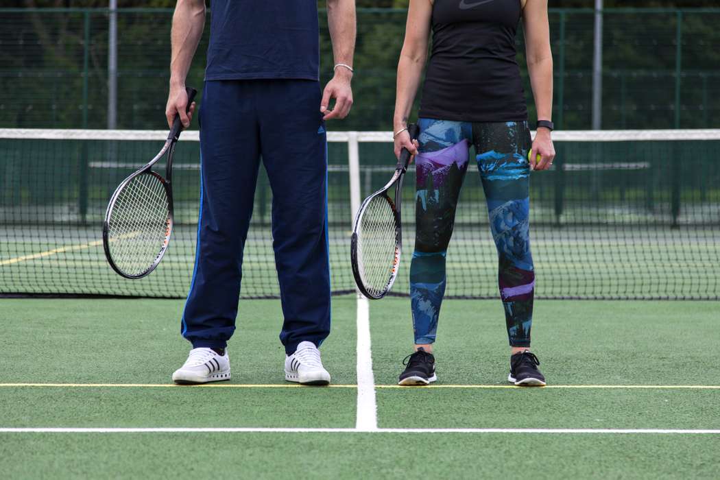 tennis courts with players standing still