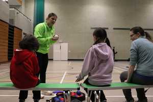 sportspark instructor teaching family boccia