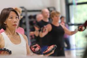 Woman holding weights in group exercise class