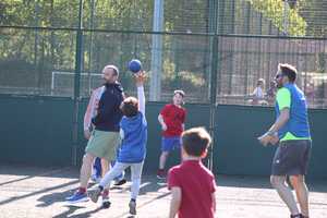 family playing handball outdoor on 3G pitch