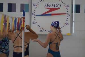 swimmers getting ready to enter pool