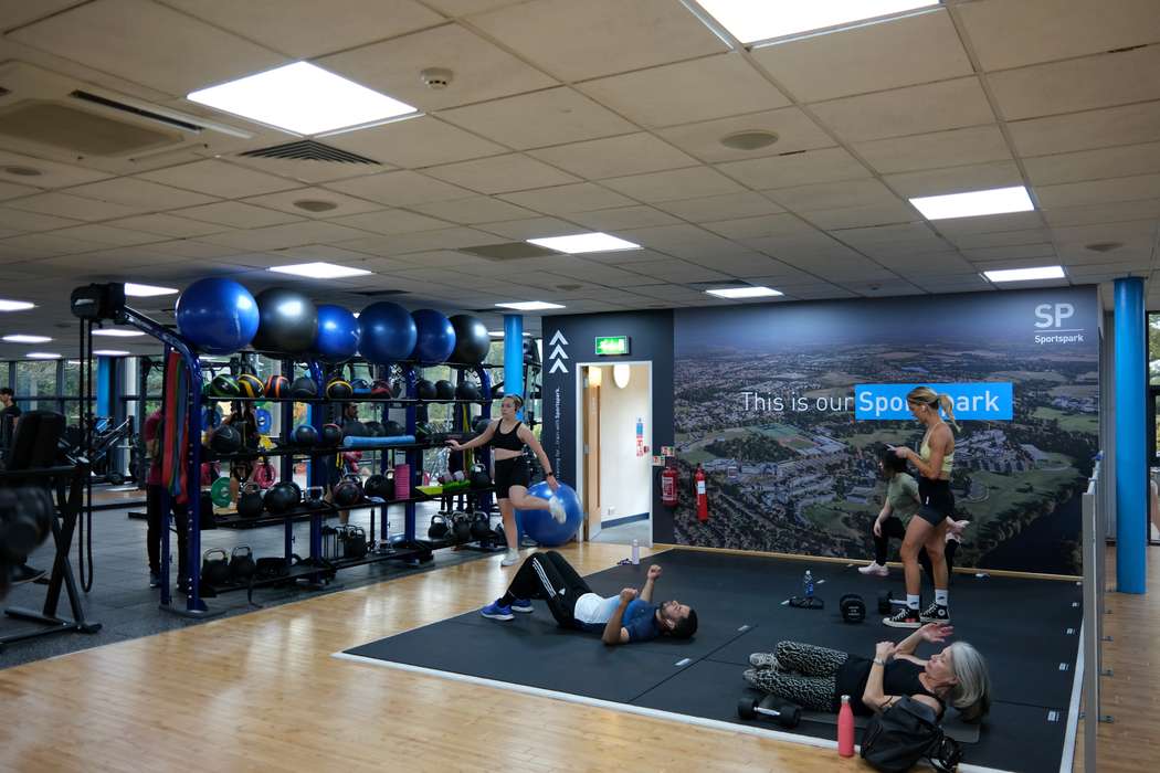 people in the fitness centre stretching area