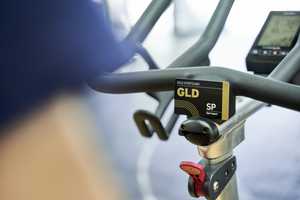 a gold card displayed in gym, resting on a machine