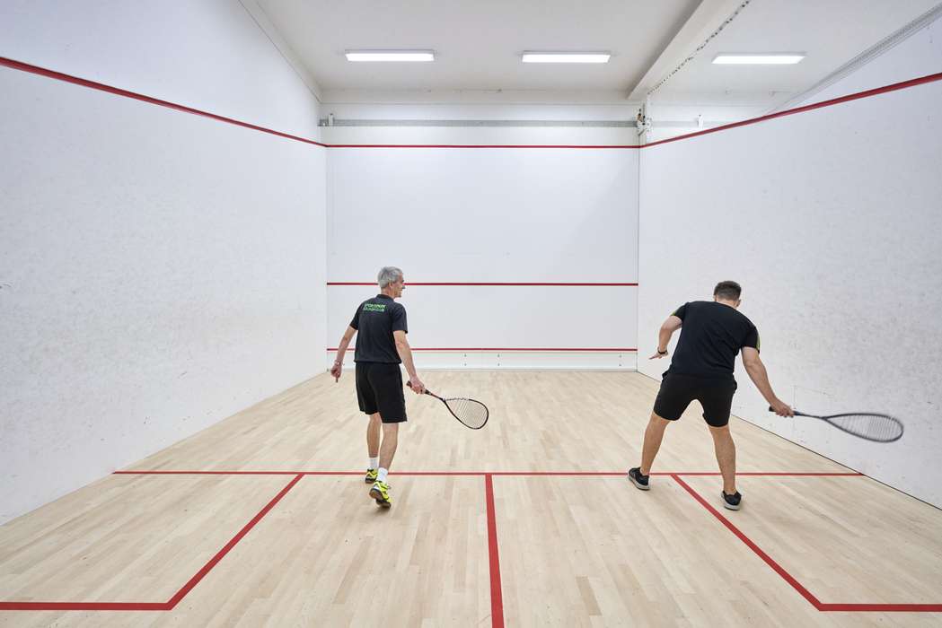 two people playing a squash match