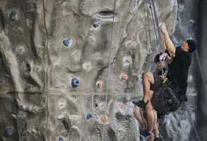 climber reaching up the wall